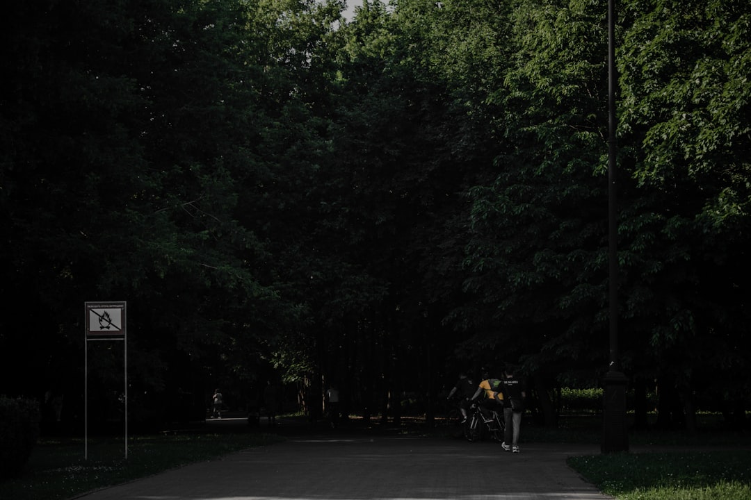 man in yellow shirt riding bicycle on road during daytime