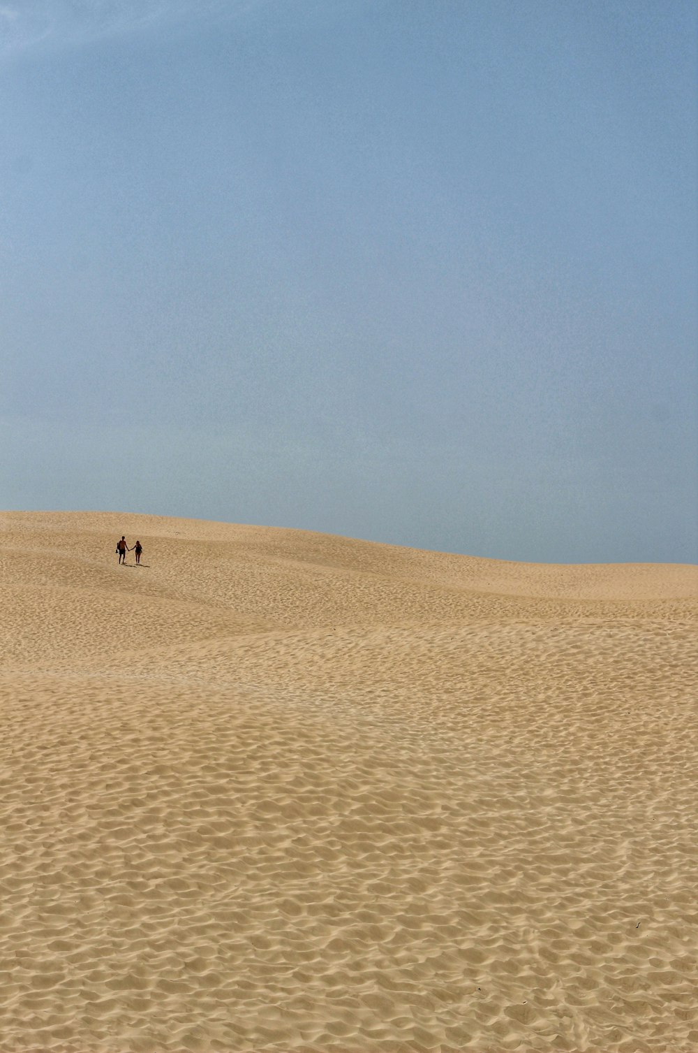 person walking on desert during daytime