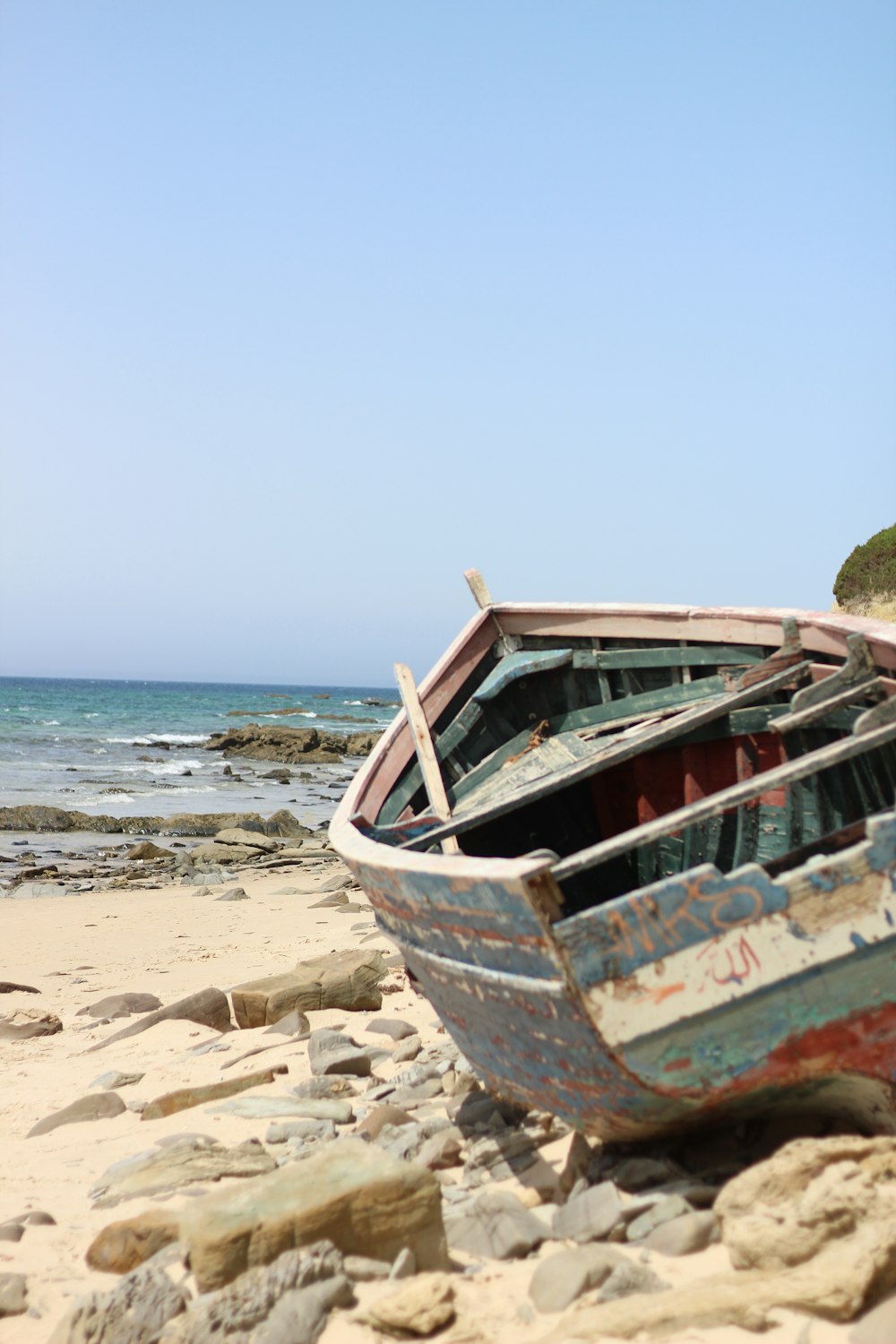 brown and white boat on beach during daytime