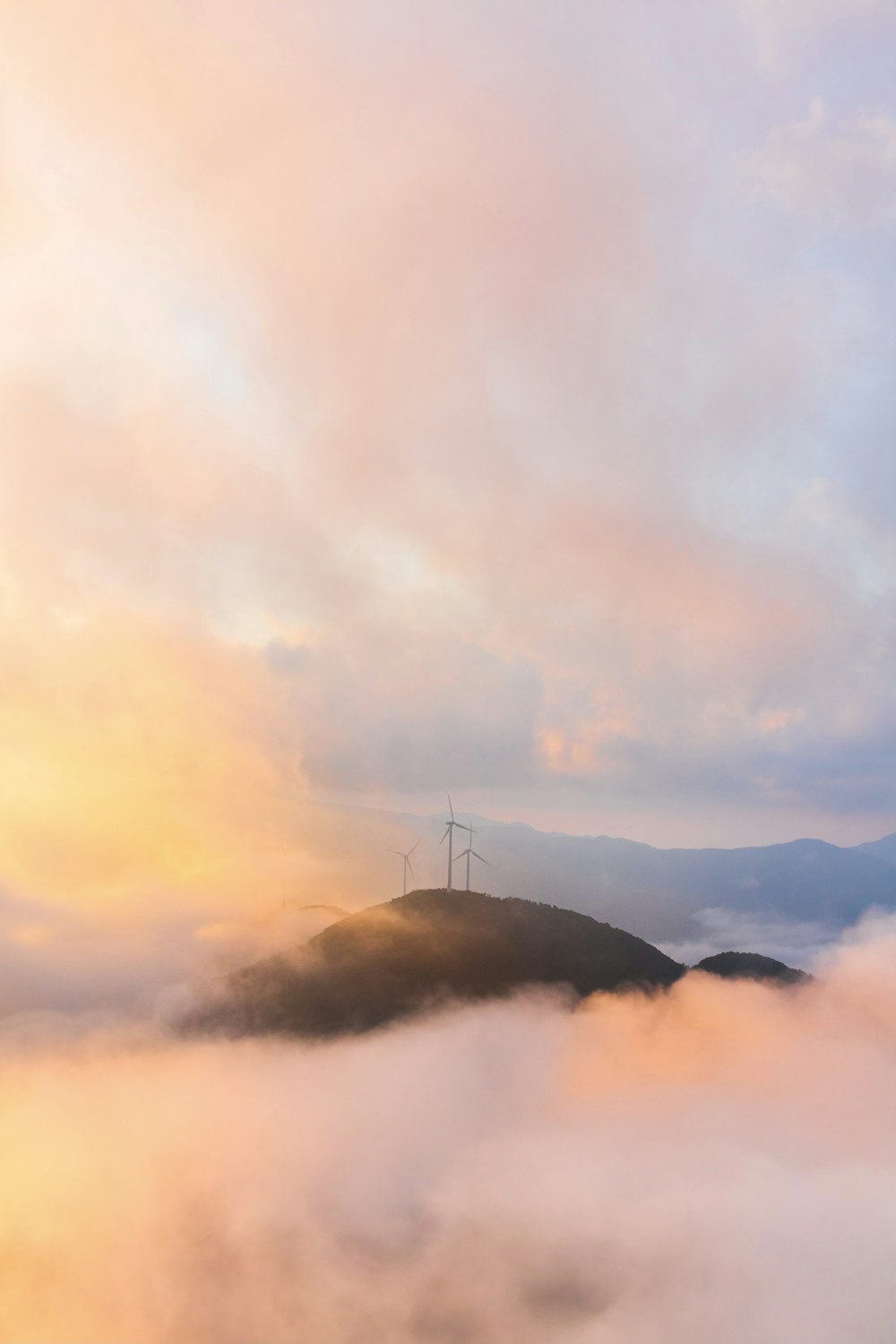 white clouds over mountain during daytime