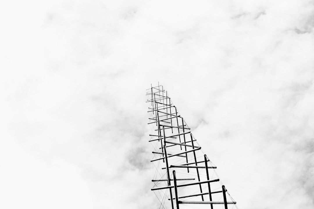 black metal tower under white clouds