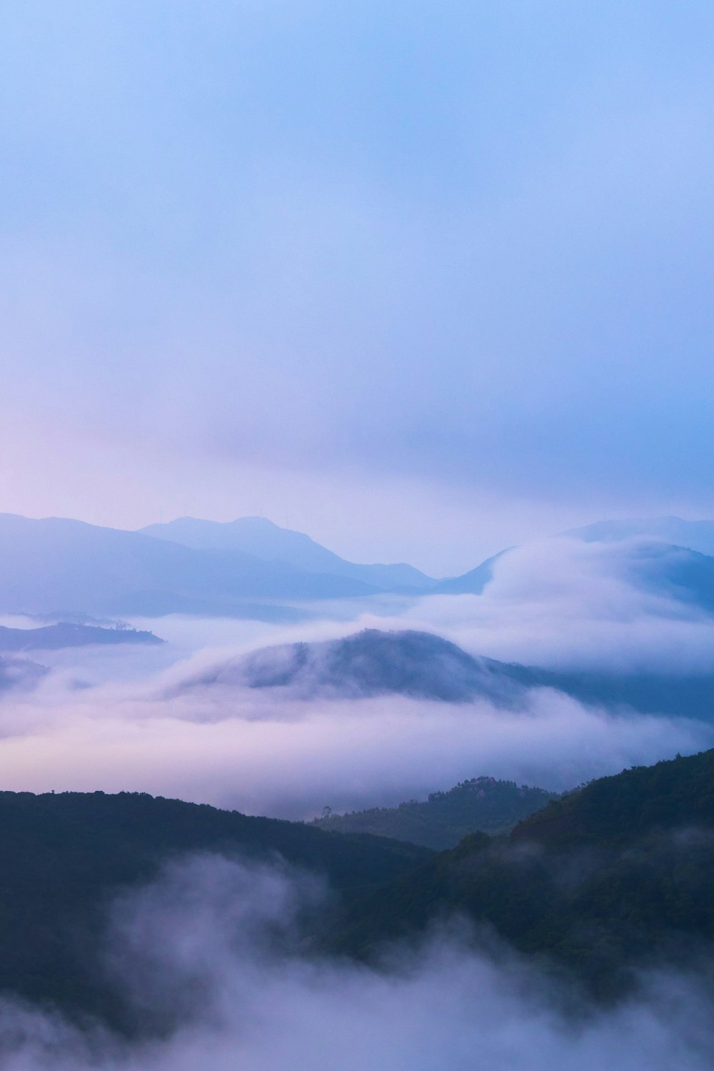 mountains covered with clouds during daytime