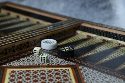 white and black ceramic mug on brown and white rug
