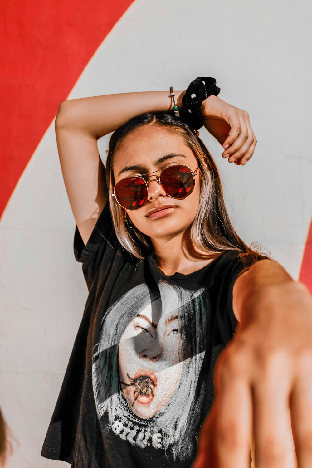 woman in black leather jacket wearing brown sunglasses