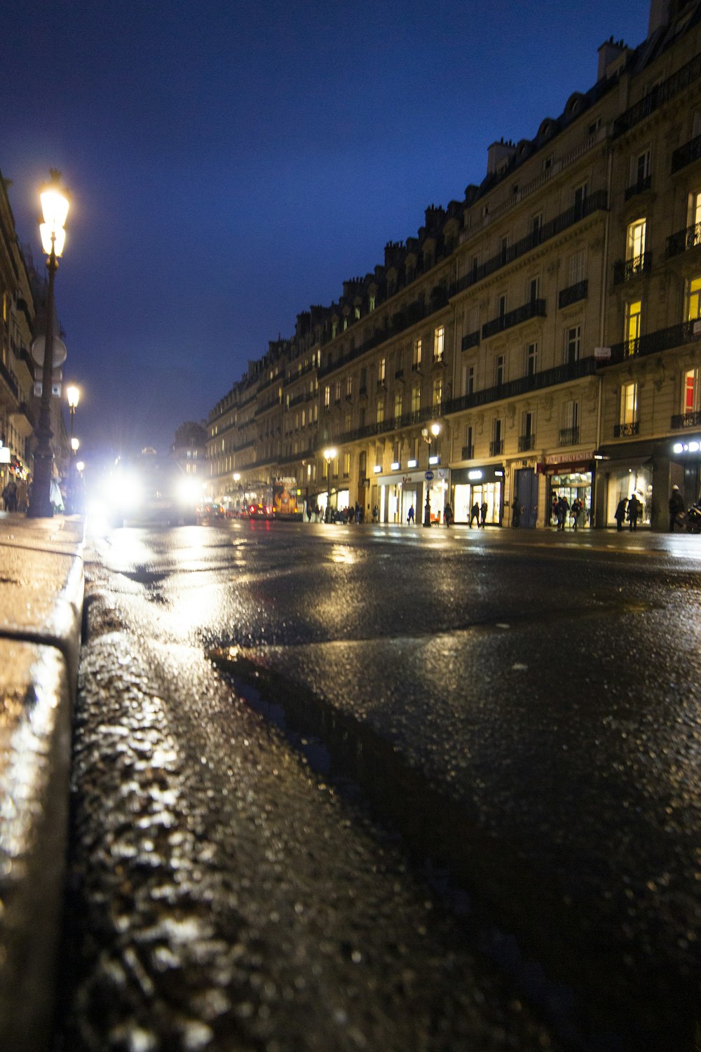 cars on road in between buildings during night time