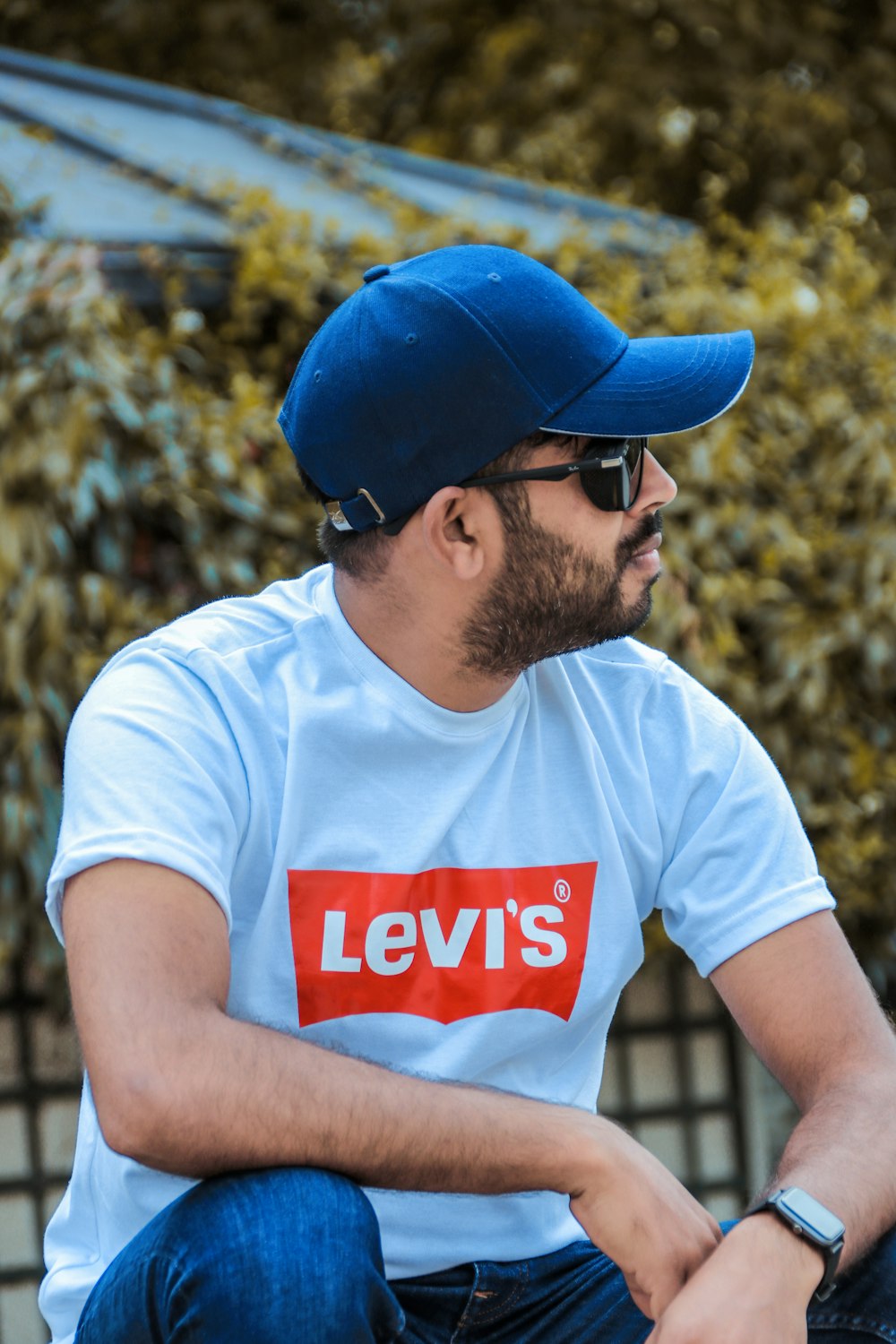 man in white crew neck t-shirt wearing blue cap and blue fitted cap