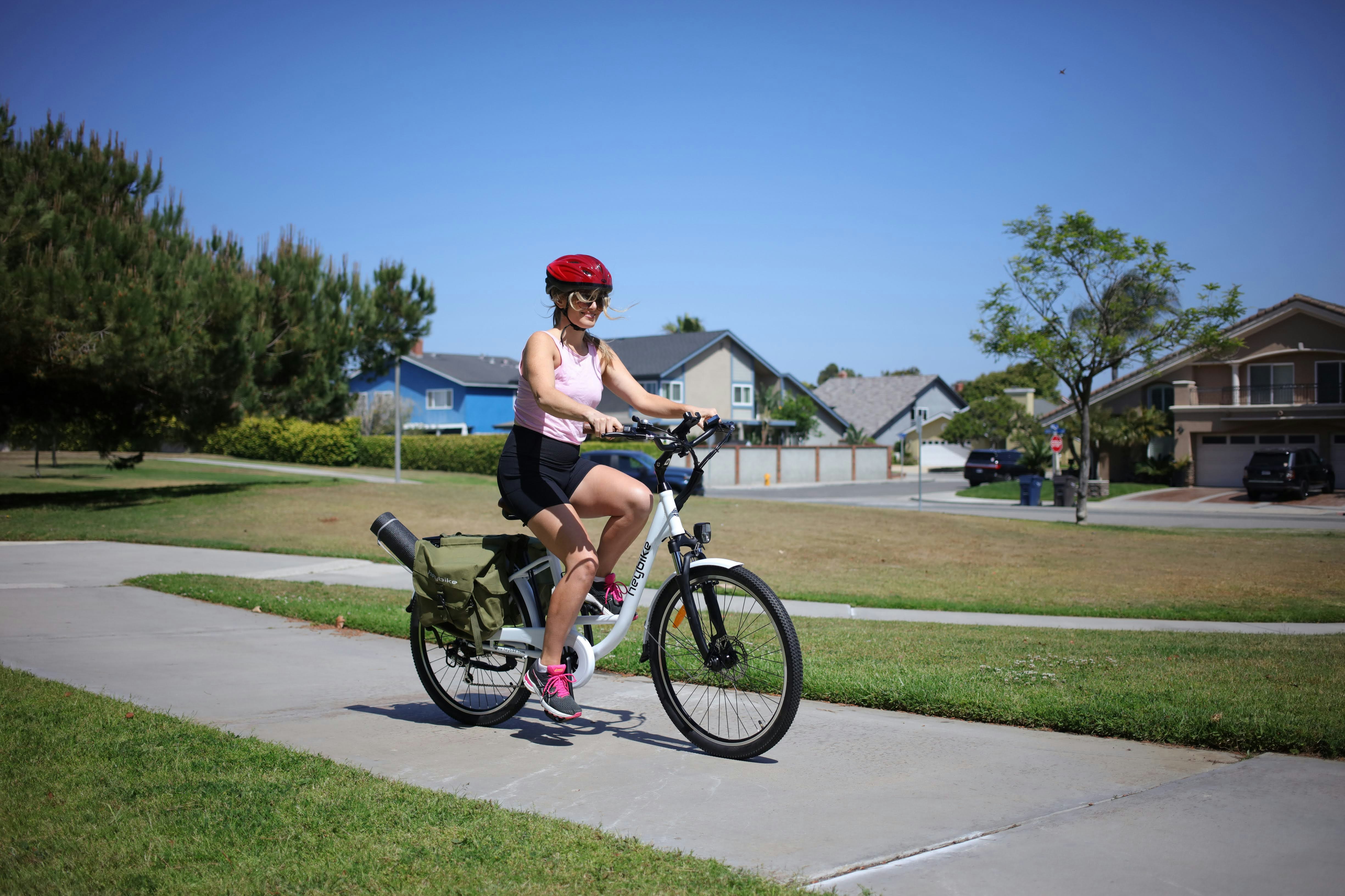 man in black tank top riding on black bicycle during daytime