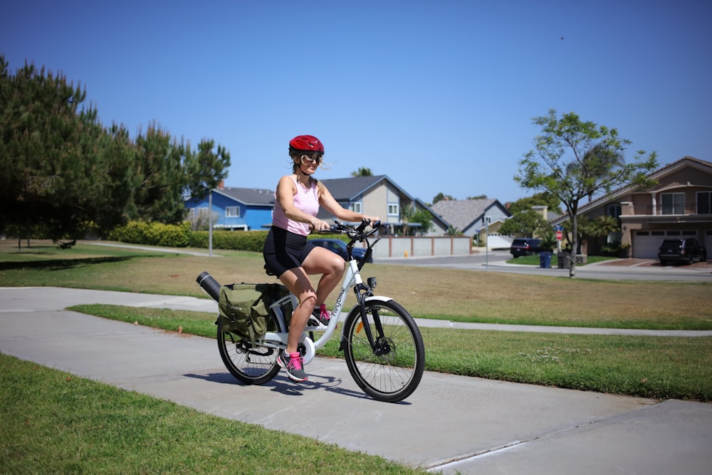 man in black tank top riding on black bicycle during daytime