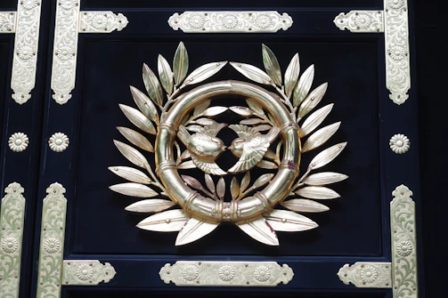 Close-up of a classic owl crest emblem embossed on a leather-bound portfolio.