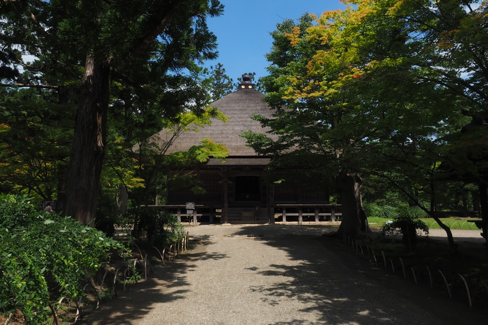 brown wooden house surrounded by trees during daytime