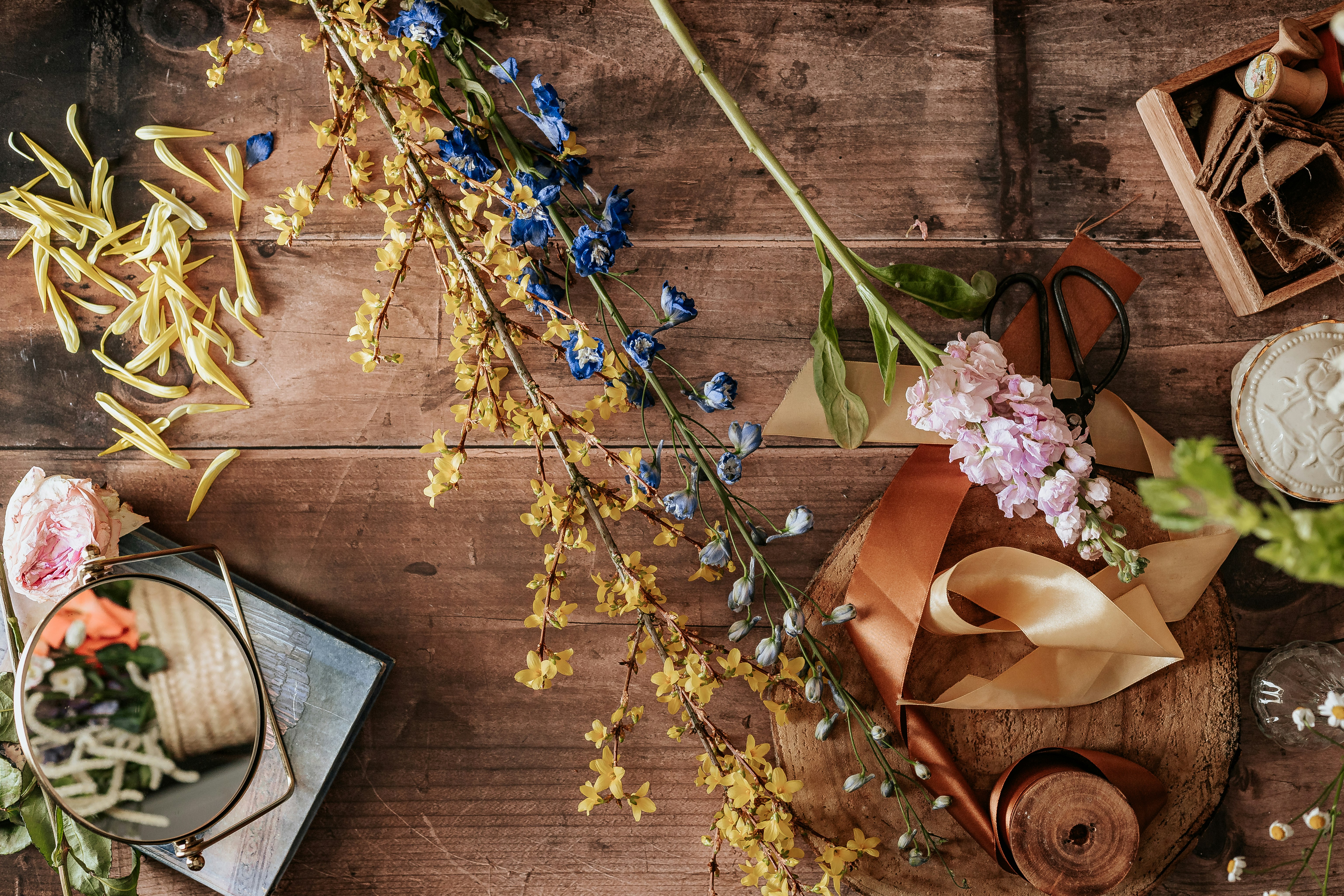 blue and yellow flowers on brown wooden table