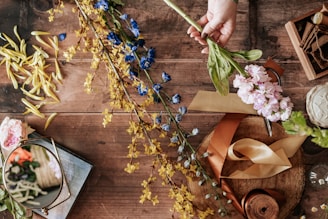Close-up of a handcrafted epoxy table featuring embedded personal items like a signed t-shirt and delicate flowers.