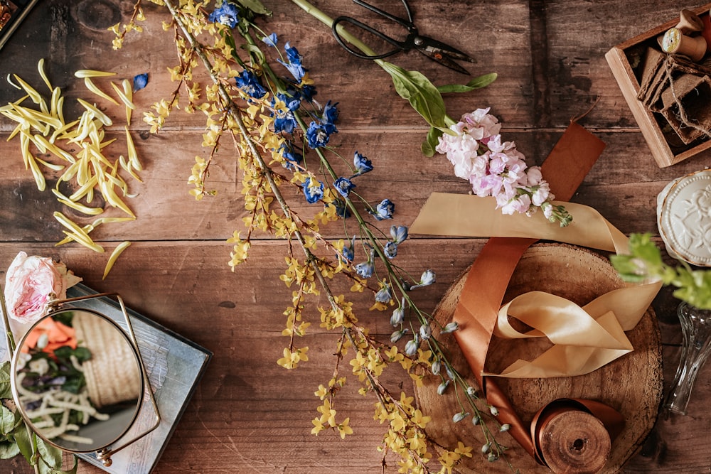 blue and white flowers on brown wooden table