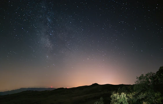 A serene rural night sky with shining stars and minimal light pollution.