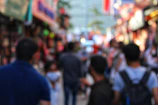 A candid shot of a lively street market bustling with colors and movement.