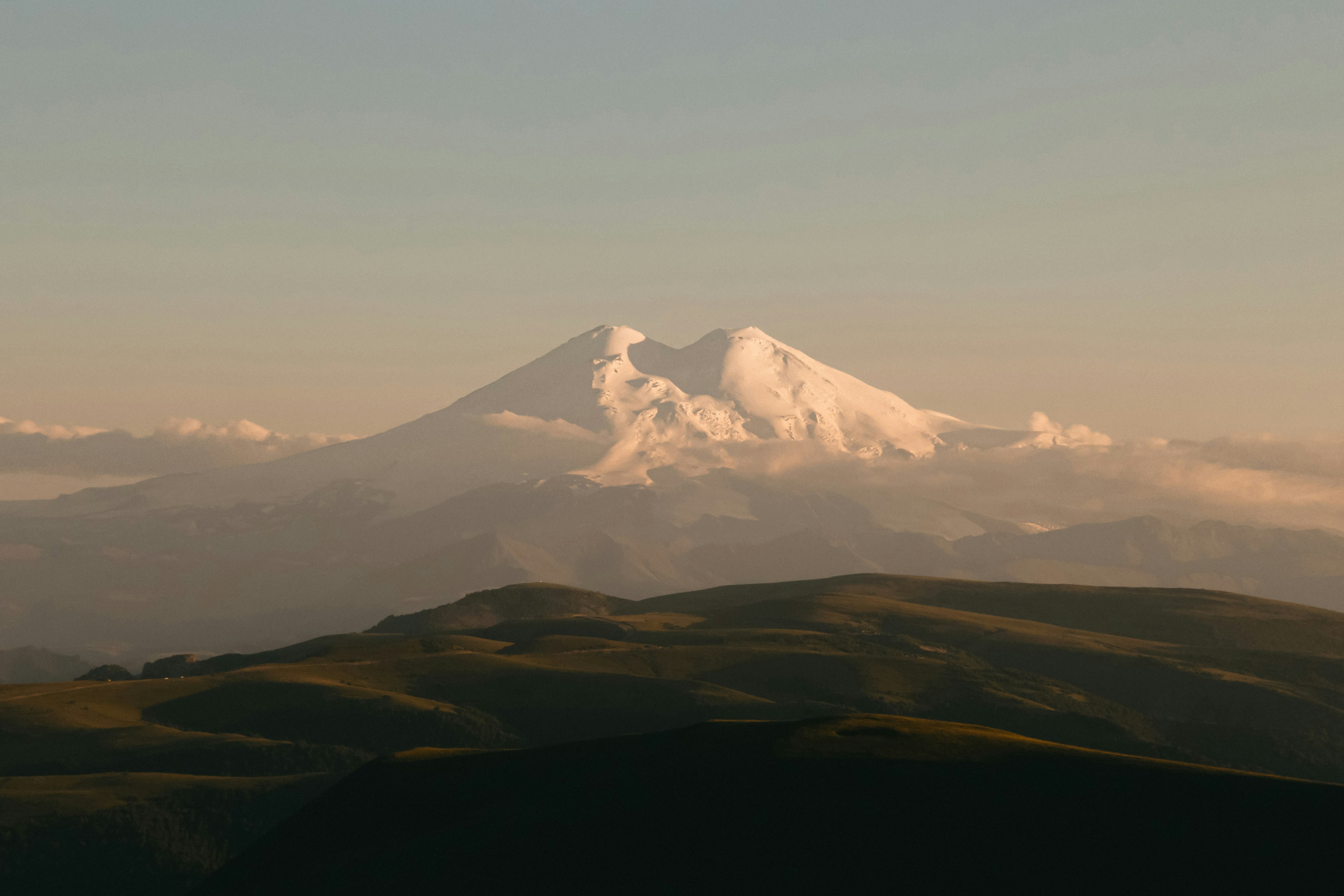 snow covered mountain under white sky during daytime