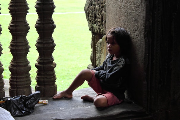 Young Miki sitting quietly in a small Buddhist temple, sunlight filtering through wooden beams