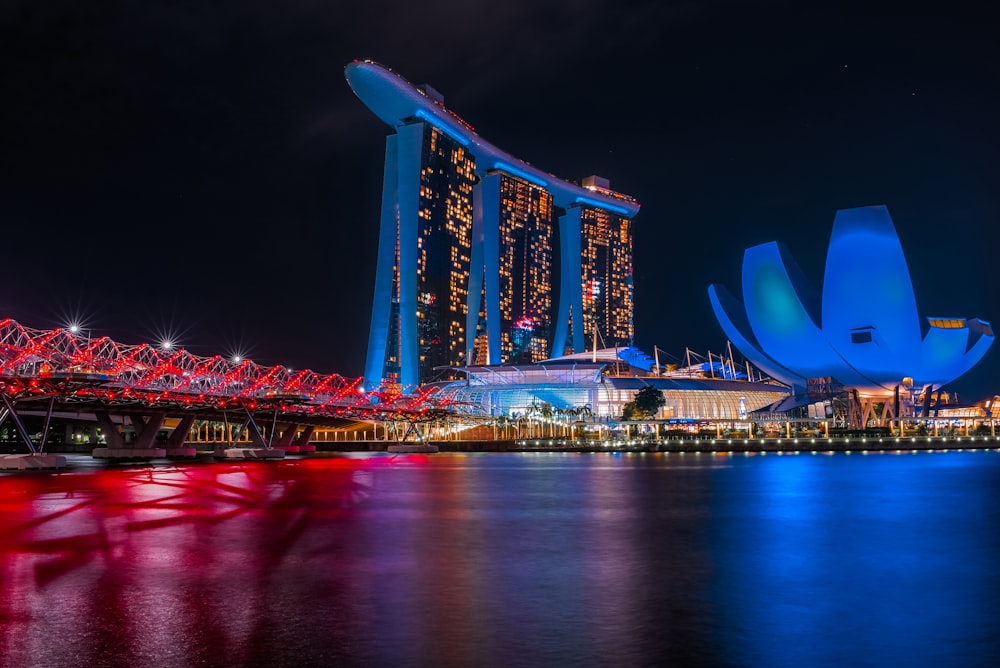 lighted building near body of water during night time