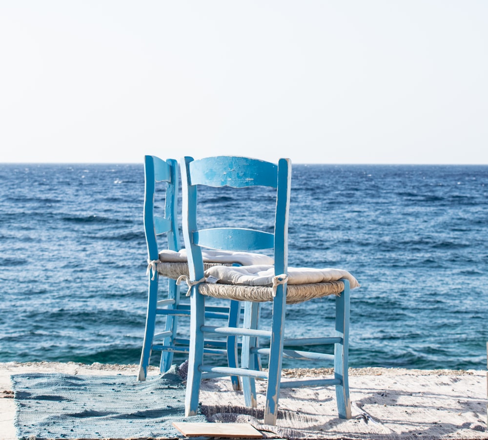 white wooden chair on beach during daytime