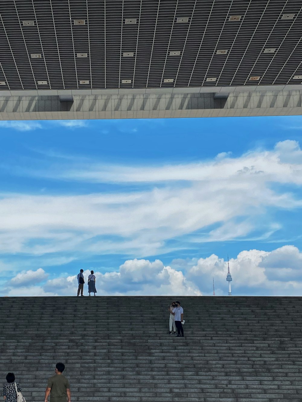 people walking on the roof under blue sky during daytime