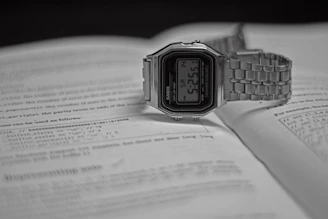 silver casio digital watch at 11 00