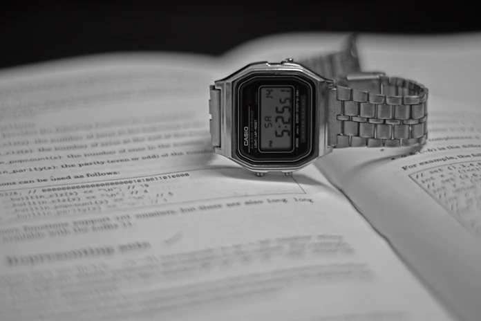 silver casio digital watch at 11 00