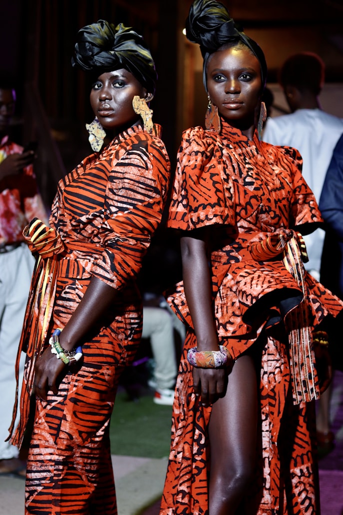 Two women modeling vibrant tiger print dresses