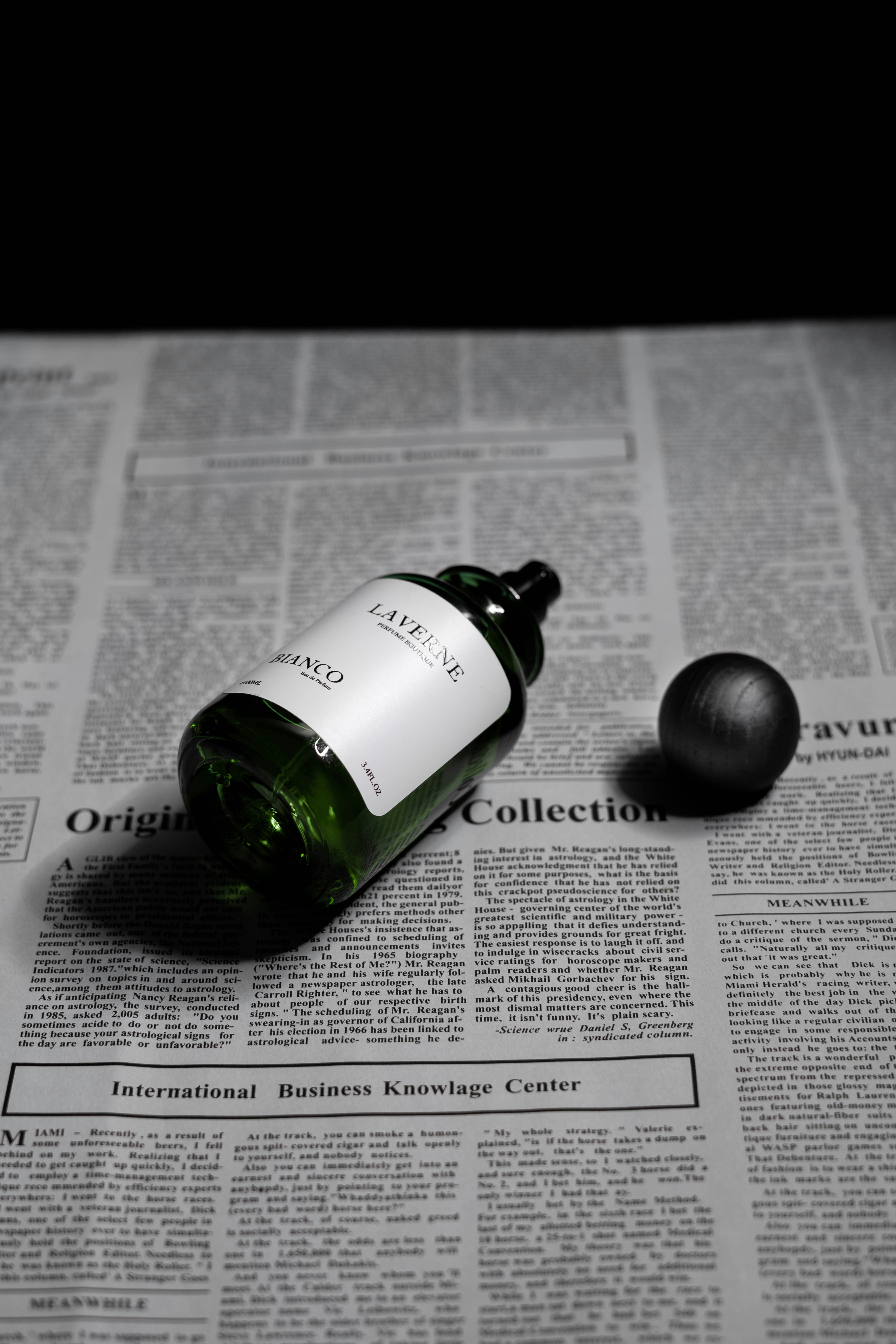 black and green bottle on white paper