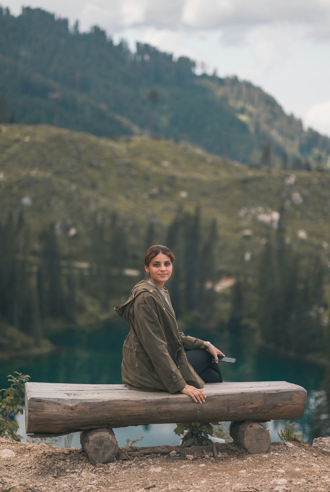 man in brown long sleeve shirt sitting on brown wooden bench