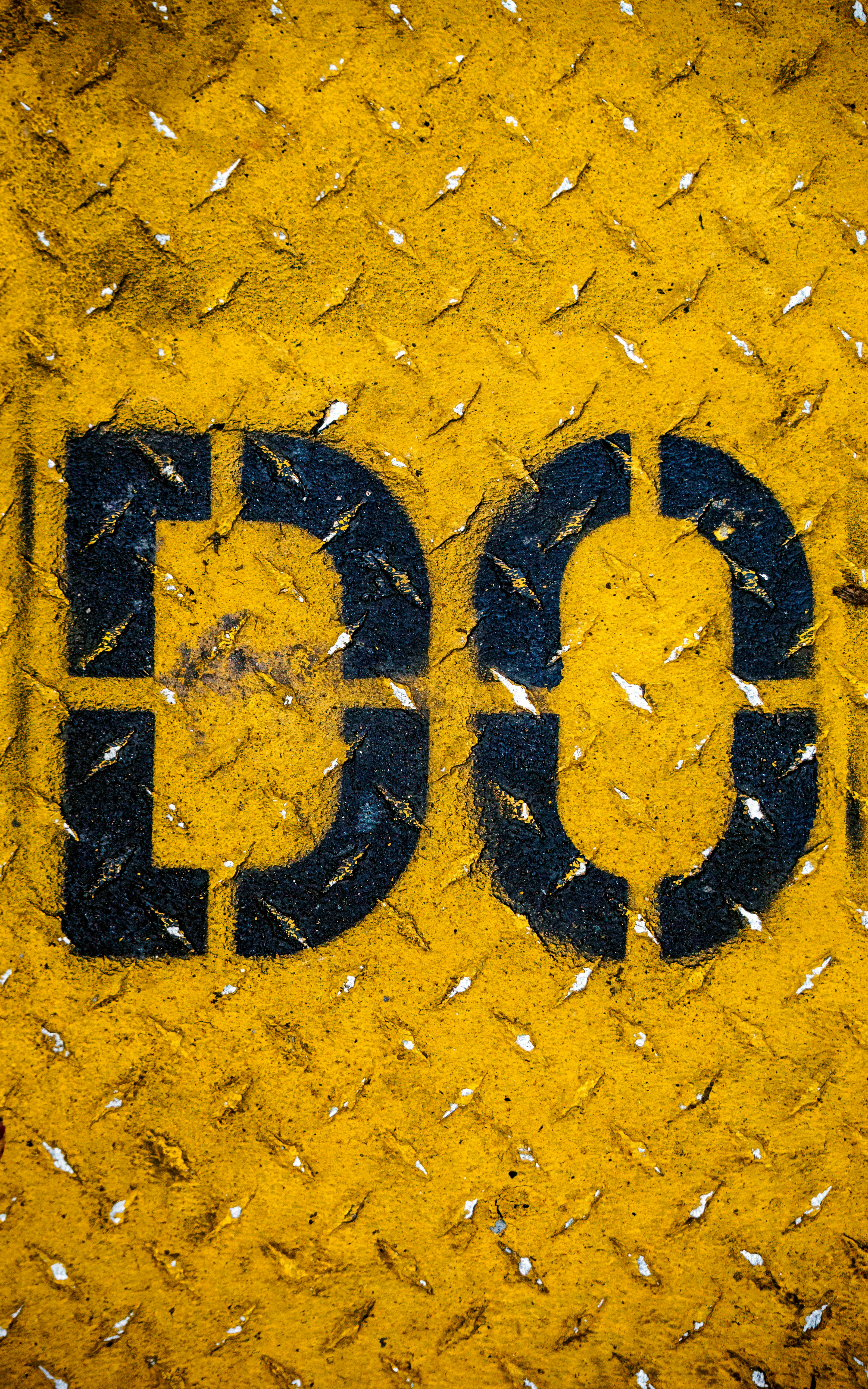 New york city ConEd street covering with spray painted lettering.