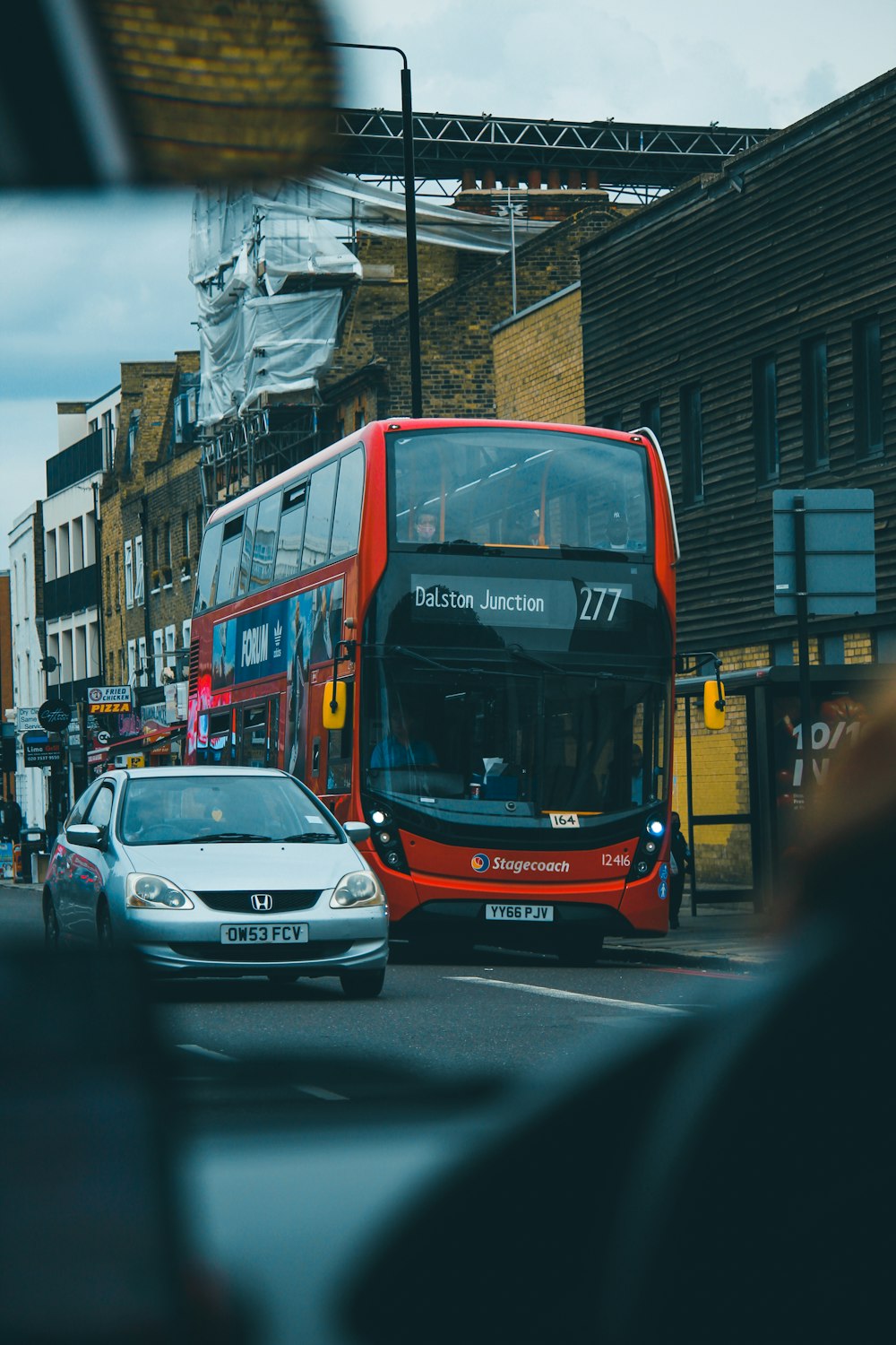 red and black bus on road during daytime