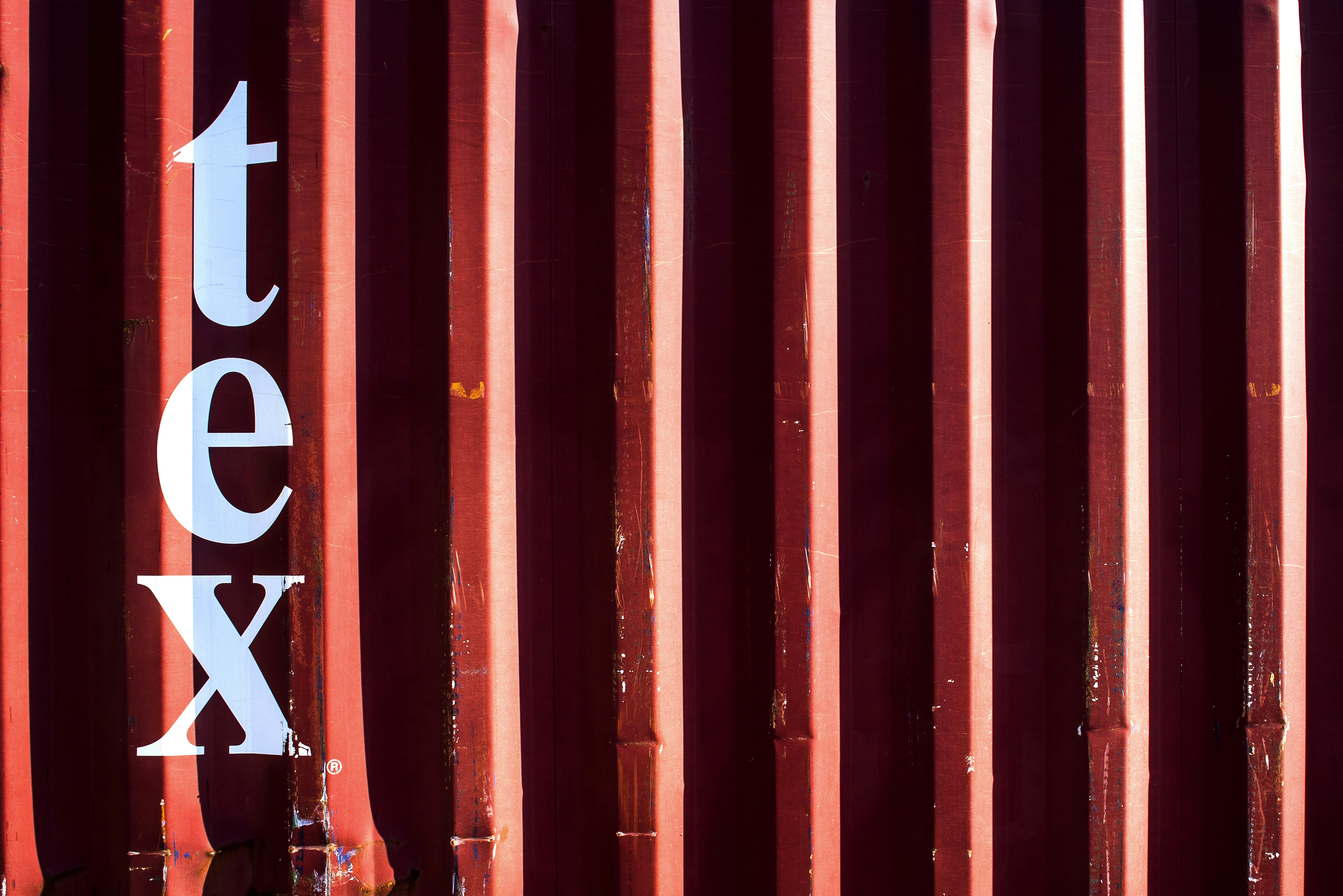 a close up of a red metal structure with the word tex on it, 
