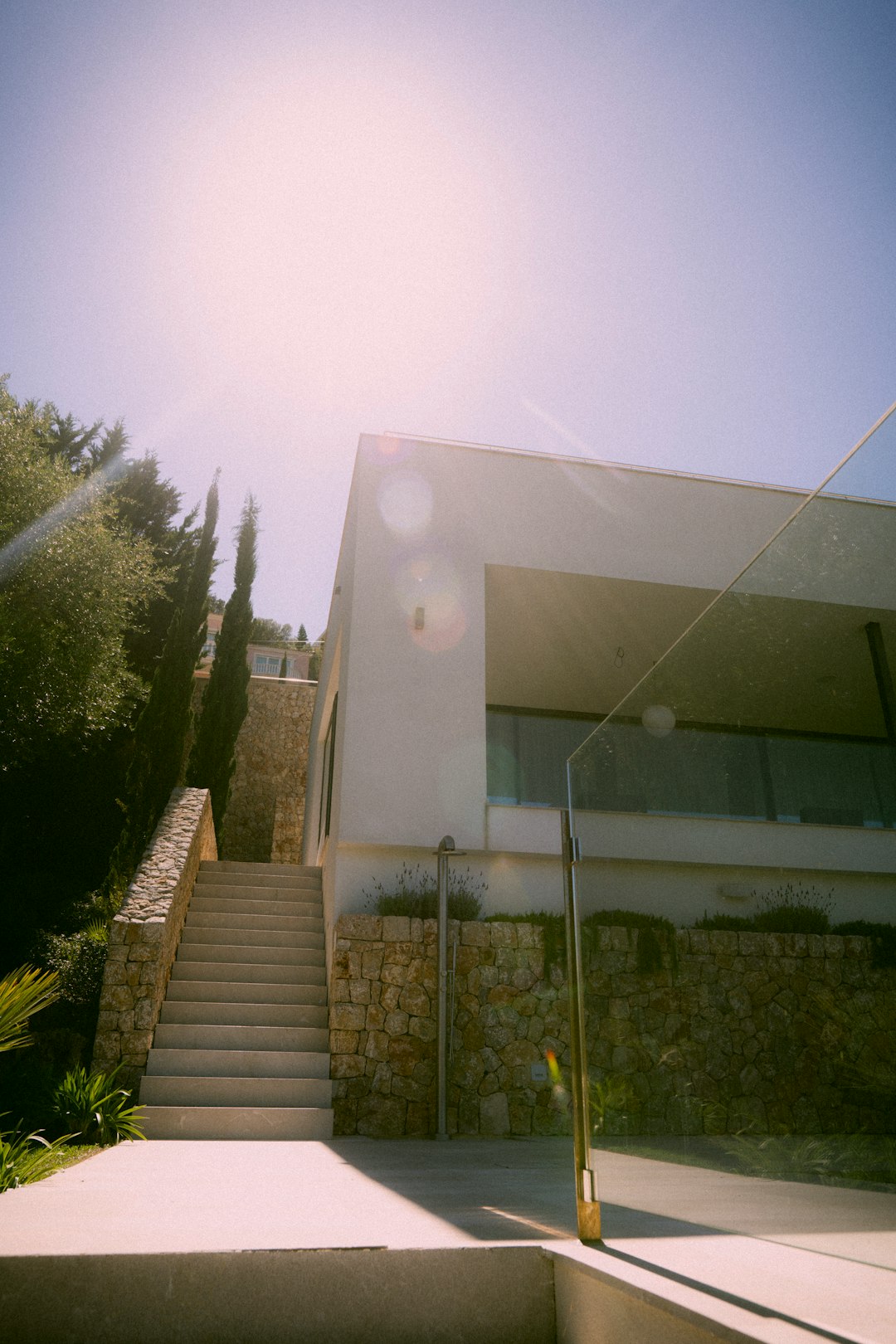 white concrete building near green trees during daytime