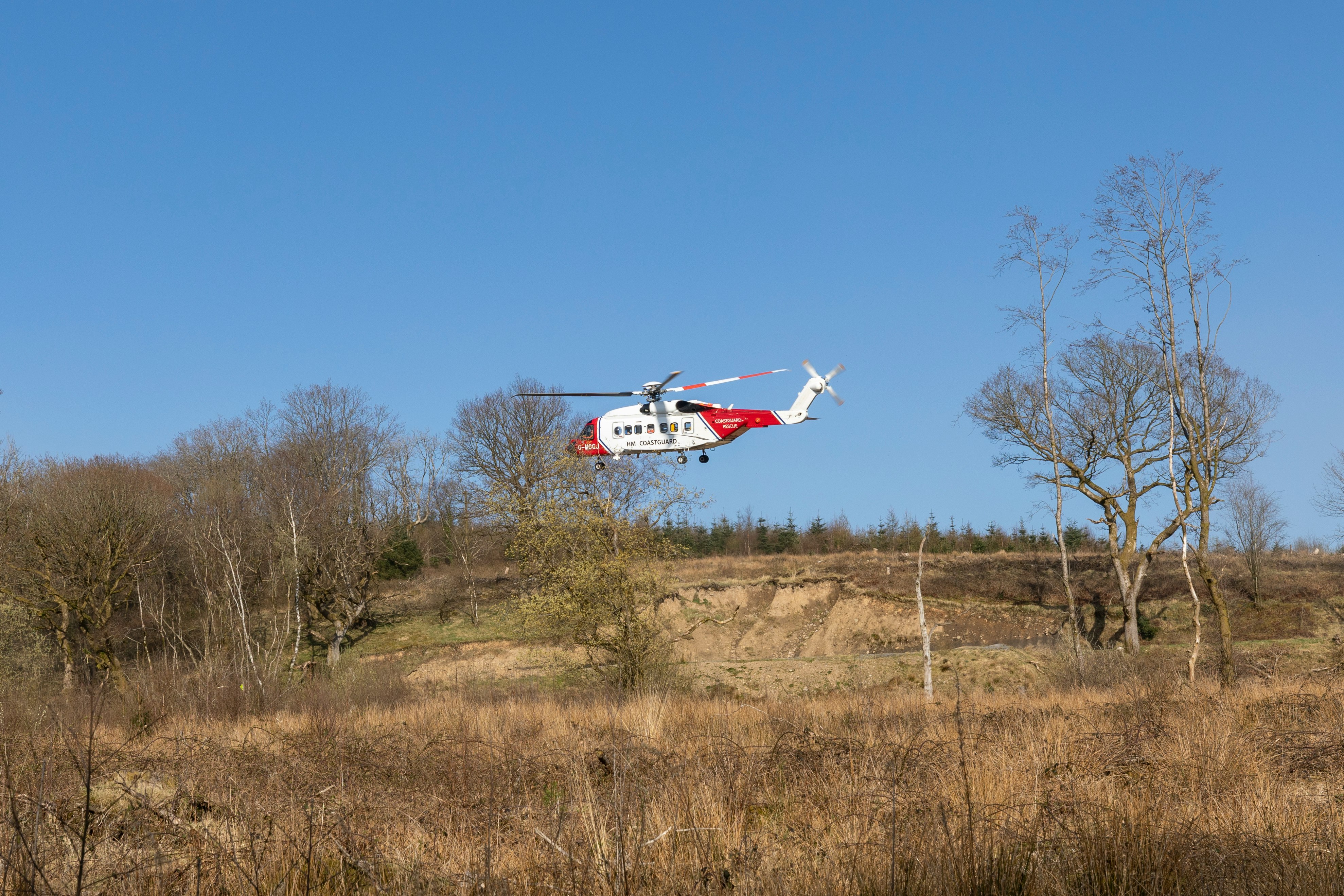 white and red airplane on brown grass field during daytime