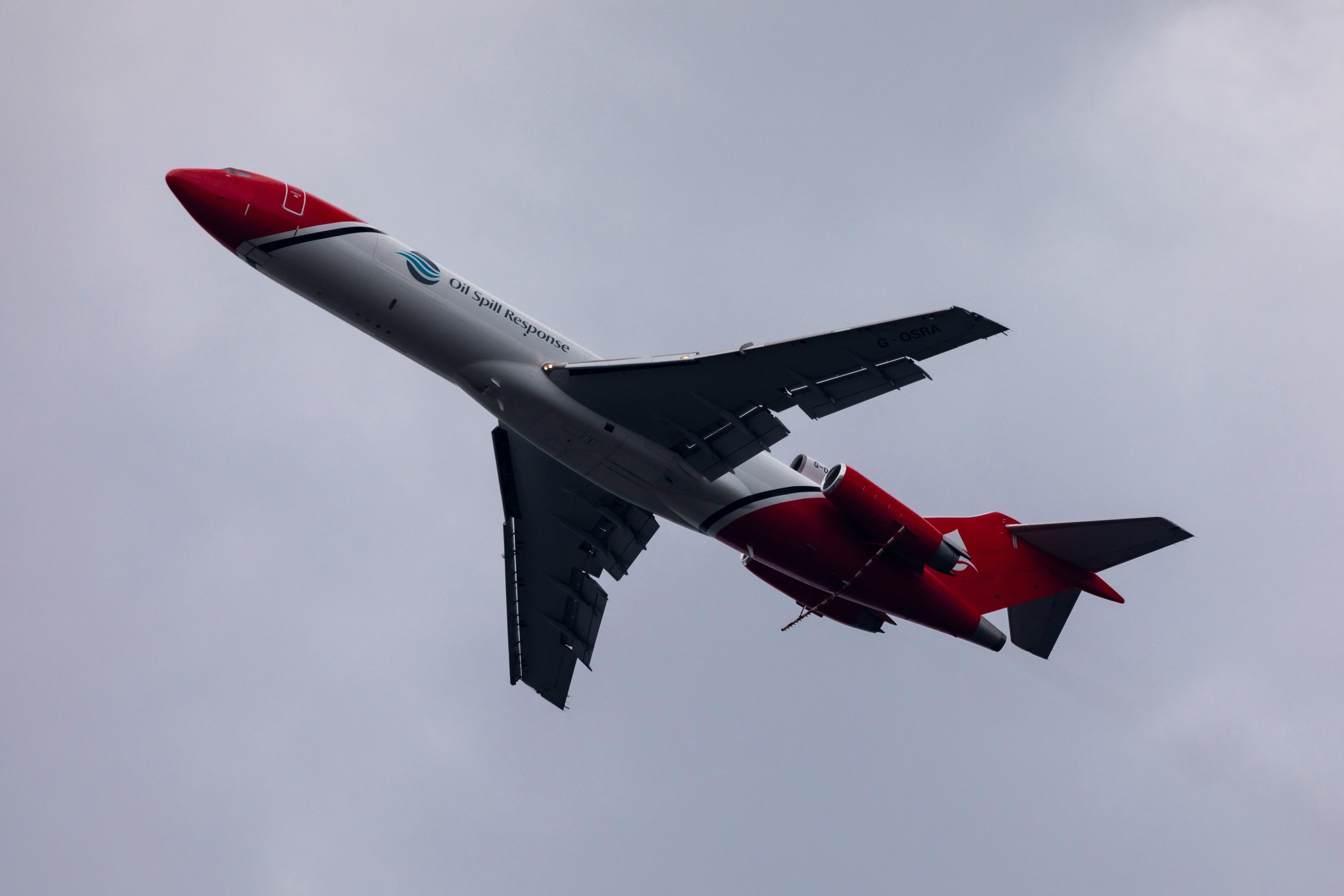 red and white jet plane in mid air