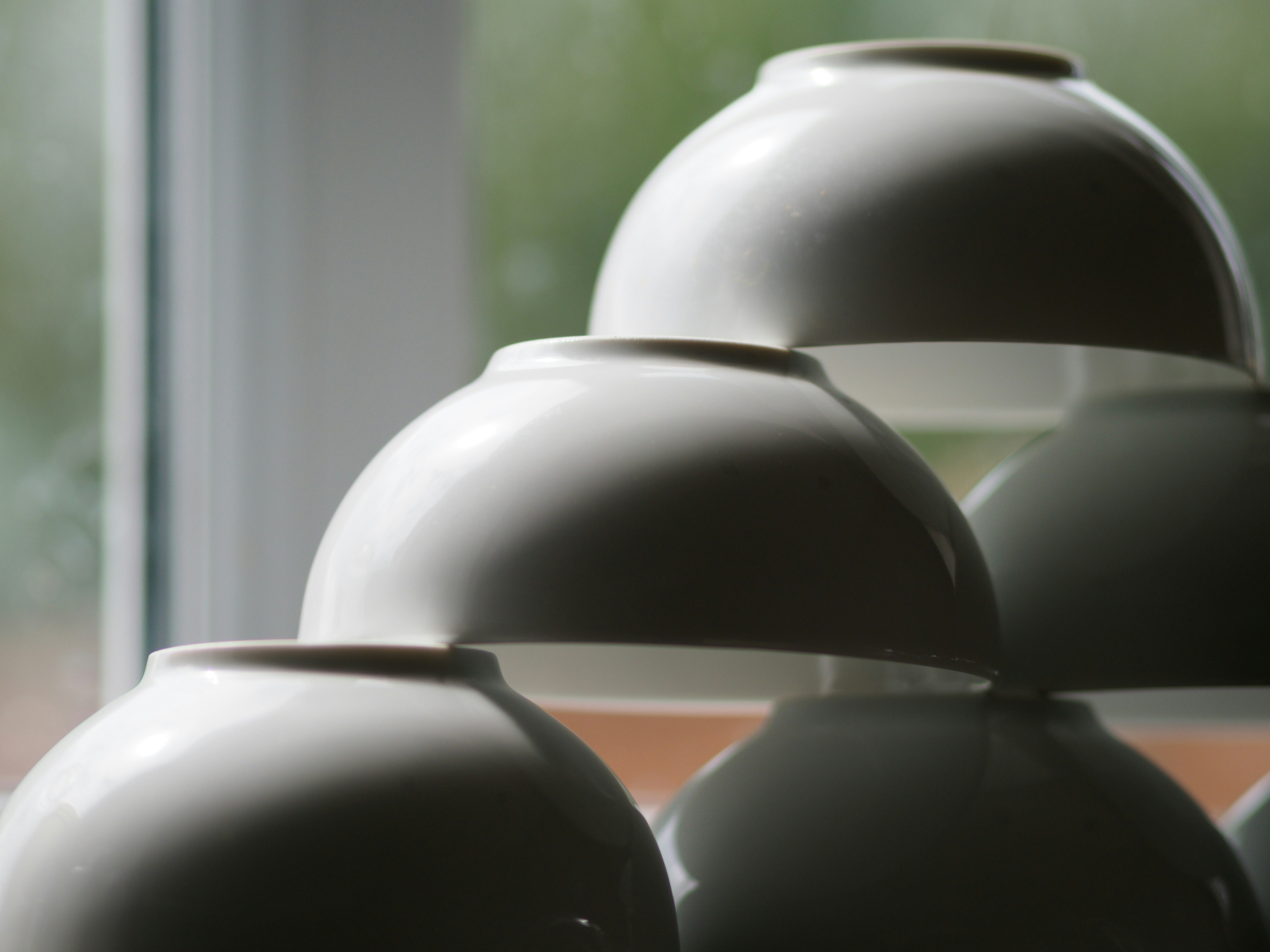 black round plastic ornament near white window curtain