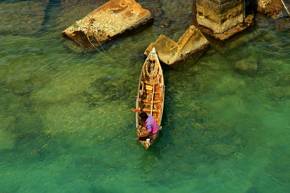 brown wooden boat on body of water during daytime