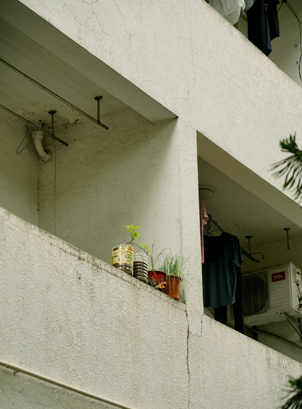 white and blue clothes hanging on white wooden door