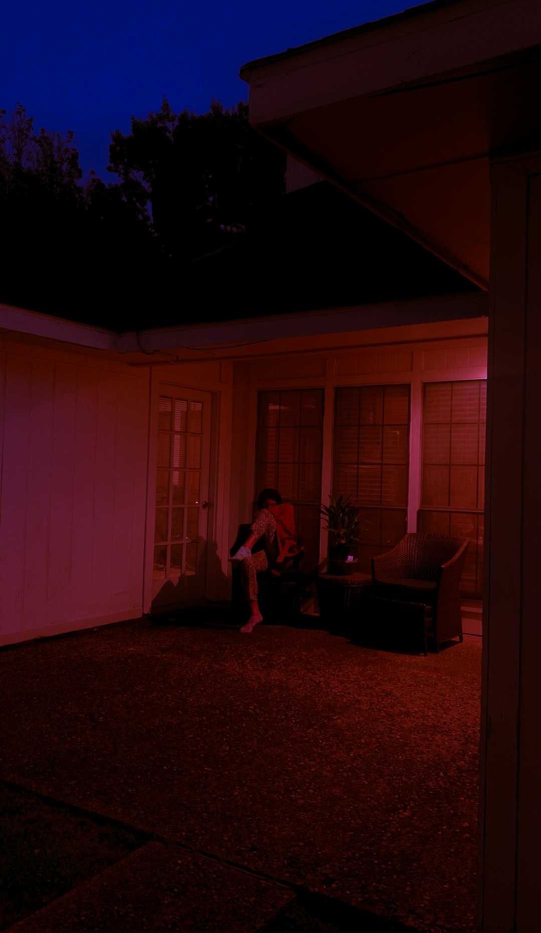 woman in pink dress standing near white wooden door