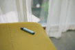An assortment of colorful cannabis vape pens neatly arranged on a rustic wooden table