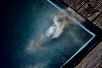 A weathered paper texture background featuring a detailed sketch of a massive zeppelin in flight.