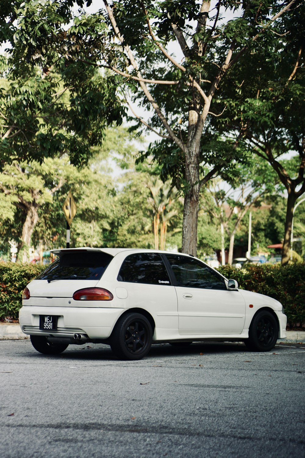 white sedan on road during daytime