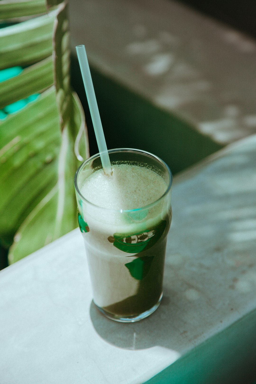 clear drinking glass with white straw