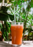 clear drinking glass with orange liquid