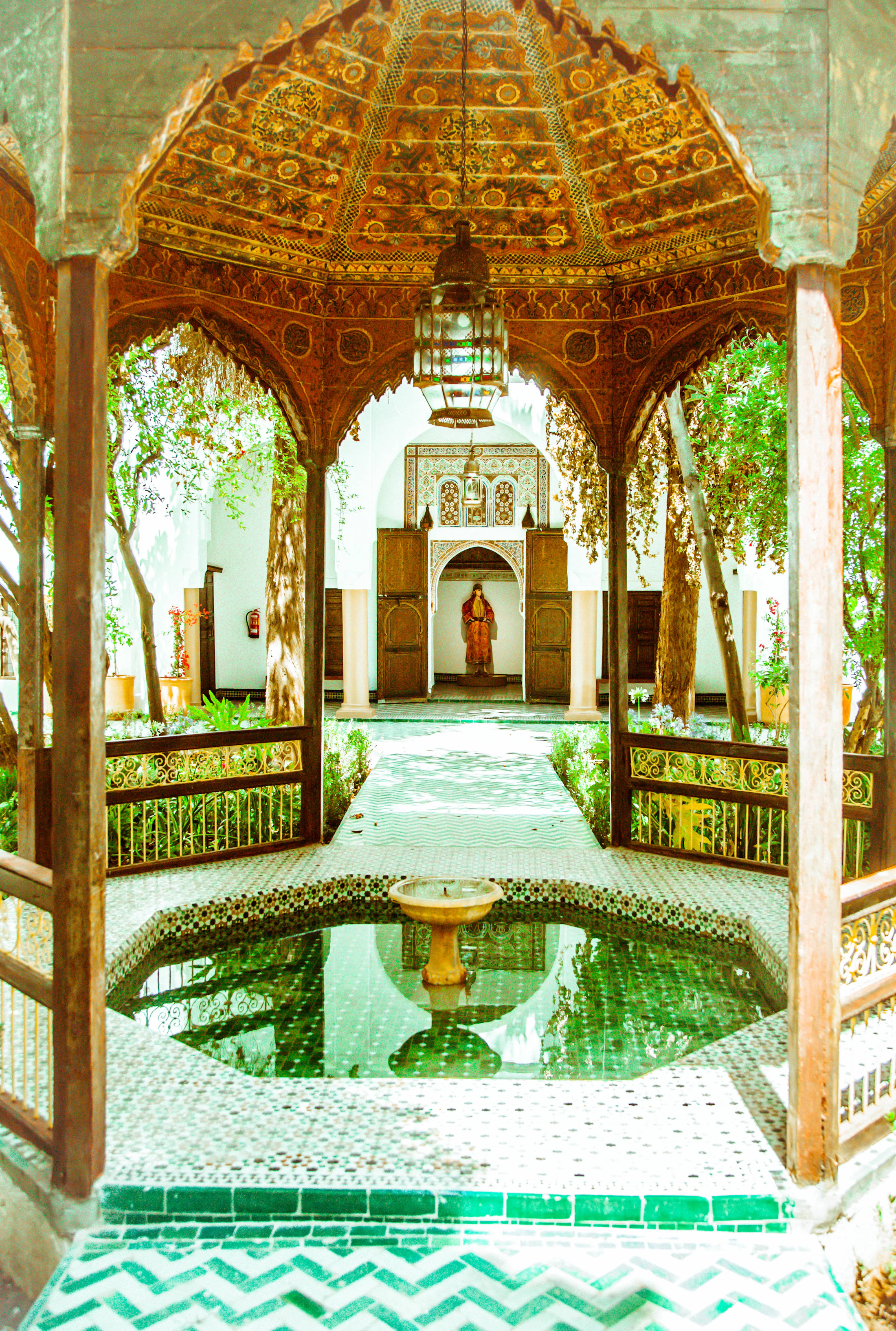 Moroccan riad courtyard with fountain and warm architectural details