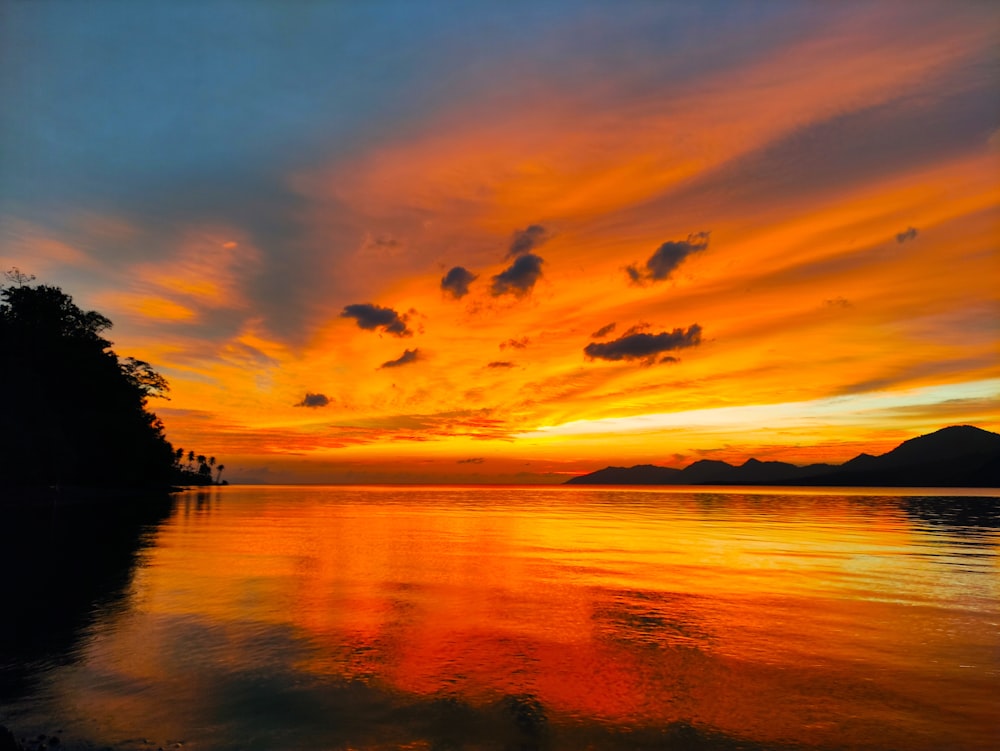 body of water during sunset