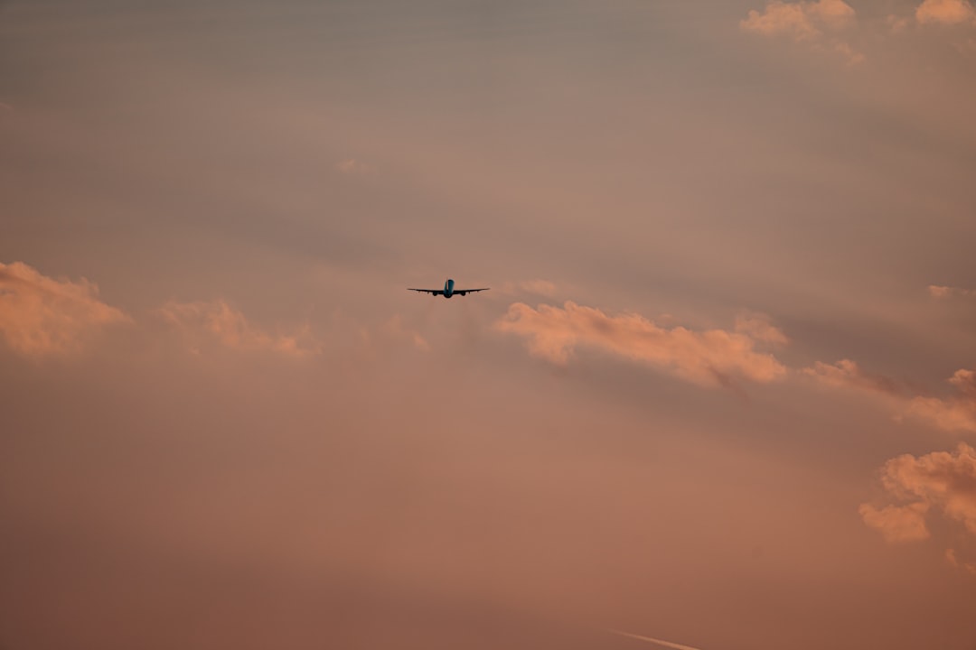 airplane flying in the sky during daytime,