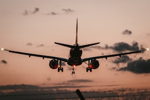 black airplane in mid air during daytime