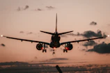 black airplane in mid air during daytime