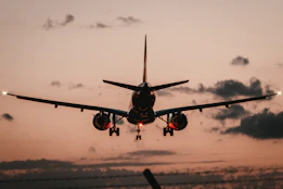 black airplane in mid air during daytime